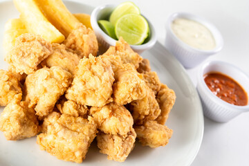 Peruvian food: chicharron de pescado or fish cracklings. White background