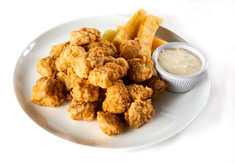 Peruvian food: chicharron de pescado or fish cracklings. White background