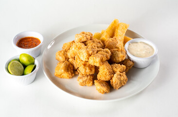 Peruvian food: chicharron de pescado or fish cracklings. White background