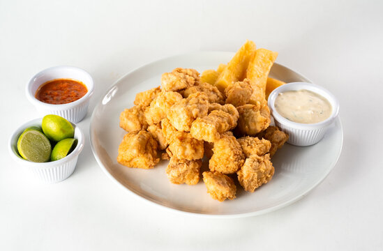Peruvian food: chicharron de pescado or fish cracklings. White background