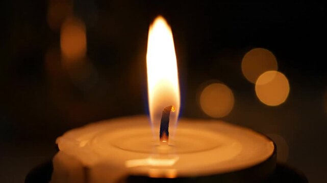 Candle light close up: relaxing candle flame for meditation and peaceful ambiance at night time