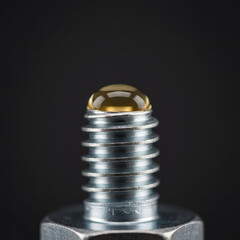 Macro View of an Oil Drop on a Metal Screw Thread