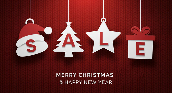 Image of the word SALE with letter-shaped ornaments hanging on red knit backdrop, Christmas and New Year concept, marketing promotional.