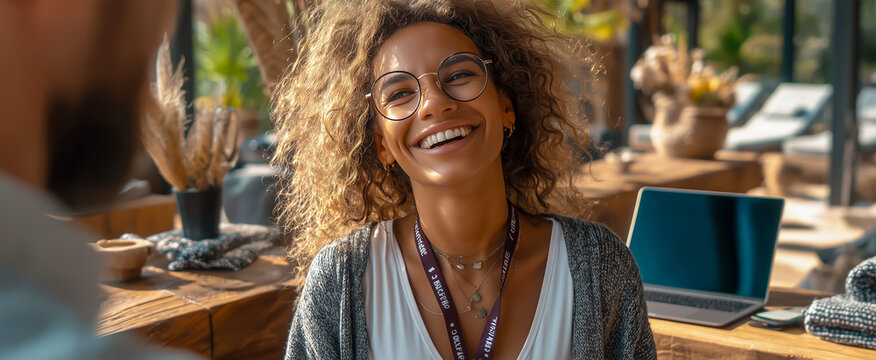 Young woman smiling happily at a coworking space desk