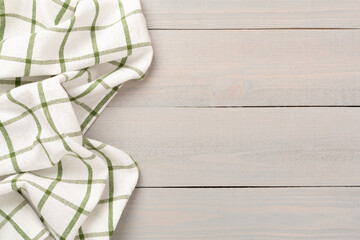 Kitchen napkin on wooden background, top view