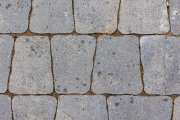 Minimalistyczny detal miejskiej architektury przedstawiający brukowaną nawierzchnię i geometryczne linie. Uniwersalne tło do projekt&oacute;w designerskich i nowoczesnych kompozycji.