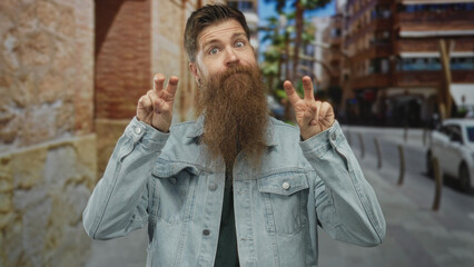 Man making air quotes with both hands on a sunlit city street amid blurred buildings and parked cars; sarcasm.