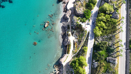 Aerial drone photo of beautiful beach with wonderful seaside promenade of Kato Petres featuring Cave Archangel Michael Panormitis, Rhodes island, Dodecanese, Greece