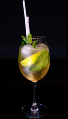 Imposing Gin Tonic or Spritz Cocktail with Mint Garnish in a Goblet Glass on Black Background