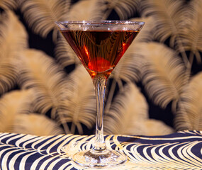Rich Manhattan or Classic Amber Cocktail in Iconic Martini Glass on Elegant Background