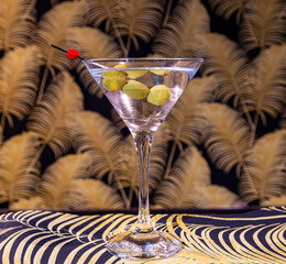 Striking Classic Dry Martini Cocktail with Green Olives in Iconic Glass