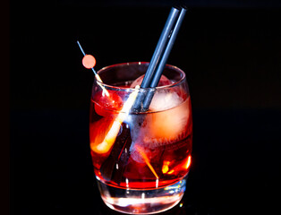Bold Classic Negroni or Old Fashioned Cocktail with Orange Peel and Large Ice Cube