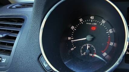 car dashboard instrument cluster showing multiple illuminated warning lights, speedometer needle at idle, fuel and temperature gauges visible, amber and red icons for engine and battery alerts, tense