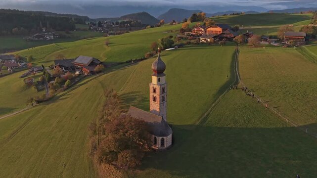 Chiesa di San Valentino with Dolomites backdrop, drone capture.