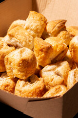 Party cocktail sausage rolls in a cardboard takeaway tray. Sustainable biodegradable plastic free recycling packaging concept