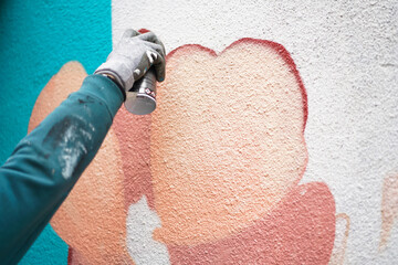 Painting graffiti on the wall. Close up. 
