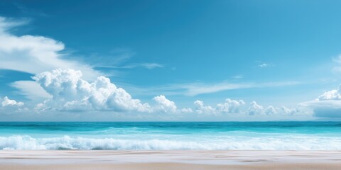Tranquil ocean waves under clear blue sky at sandy beach