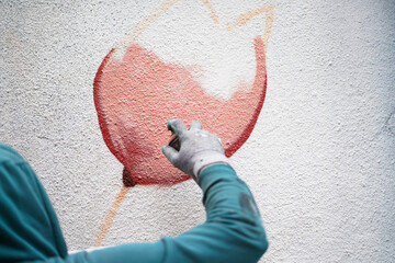 Painting graffiti on the wall. Close up. 