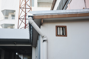 White Drainpipe Building With Small