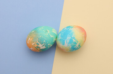 Colored Easter egg on pastel background. Top view