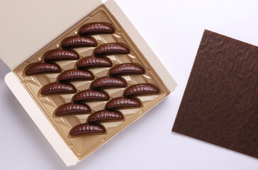 Box of chocolate candies  on white background. Top view