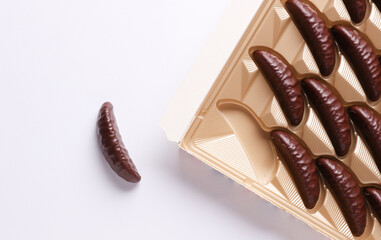 Box of chocolate candies on white background. Top view