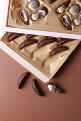 Boxes of chocolate candies on brown background. Top view