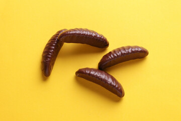 Chocolate candies on yellow background. Top view