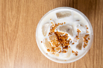 Iced coffee latte with creamy cold foam and caramel crumble. Close up view of Salted caramel milkshake with coffee