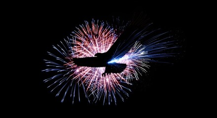 Eagle silhouette soars amidst vibrant fireworks