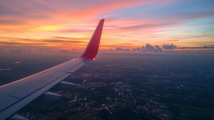 Aerial View of Cityscape at Sunset from Airplane Window