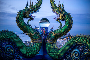 Background of Thailand's Chonburi religious attractions (Wat Khao Phra Khru viewpoint), with beautiful Buddha and Phaya Naga statues, tourists always come to make merit and take pictures at night.
