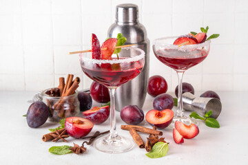 Sugar plum autumn winter sweet tasty drink. Alcohol or non-alcohol cocktail, mocktail with plum syrup, hard liqueur, spices, cinnamon and mint, copy space
