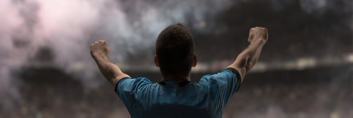 Football striker lifting shirt celebration crowd arms raised joy