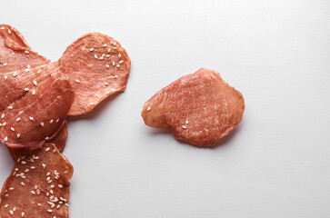 Meat chips with sesame seeds on a white background
