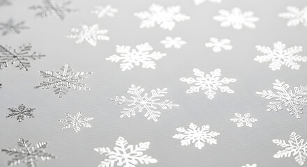 Silver foil snowflake pattern on grey paper background