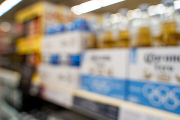 Blurred view of liquor bottles on store shelf.