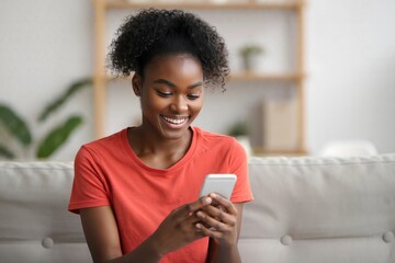 Young african american woman using smartphone at home smiling and texting