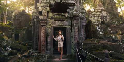 Sunlit Ta Prohm Khmer Temple With Backpacking Woman, Angkor Cambodia