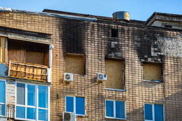 The facade of the building after the fire. The high-rise brick apartment building was damaged by the fire