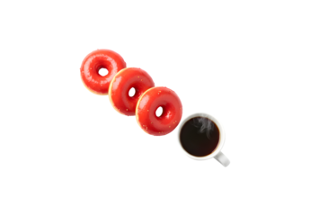 Three red donuts and a cup set against a white background, leaving room for text. A mug filled with tea or coffee alongside the dessert. Sweet treats.