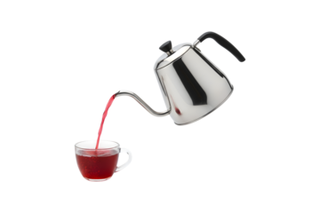 A tea kettle pouring red tea against a white backdrop

