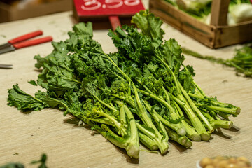 Cime di rapa, turnip greens, rapini or broccoli rabe in a street food market, green cruciferous vegetable, veggies, mediterranean cuisine, Puglia, Italy