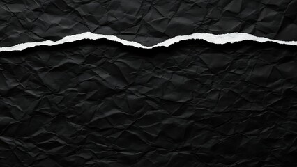 Torn black paper texture background with rough edges.