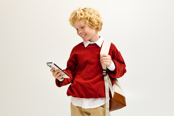Excitement fills the air as a stylish child checks their phone after school