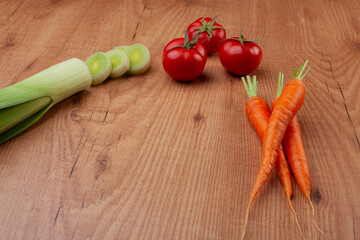 Seasonal vegetables on a dark wooden background.