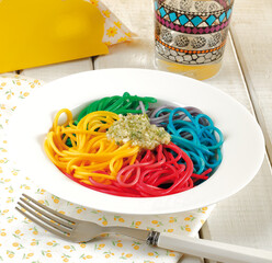 Cooked spaghetti with food coloring for kids.