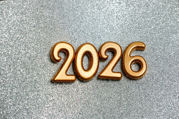Golden numbers 2026 on a sparkling background. New Year's celebration concept.