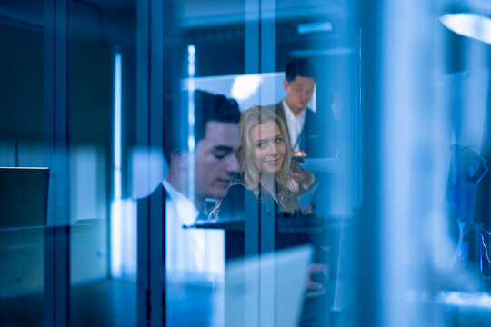 In a futuristic high-security office, a corporate intelligence analyst conducts a covert digital forensics investigation, tracking the source of a sophisticated industrial espionage attempt.