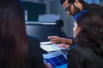 A lead AI architect and two female ethicists collaborate on the core logic and safety protocols for a new generative AI, designing an autonomous customer service platform for a global client.